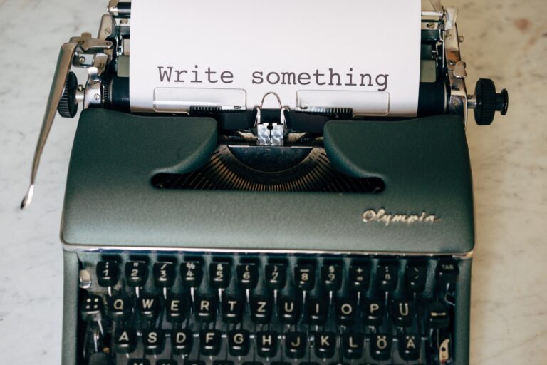 Typewriter with paper reading "Write something